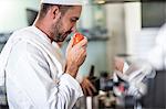 Chef smelling tomato