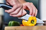 Chef slicing yellow pepper, close-up