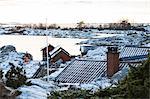 Buildings on rocky coast at winter