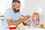 Father feeding girl