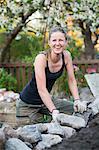 Smiling woman working in garden