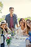 Friends enjoying weekend meal together, portrait