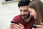 Couple using smartphone together