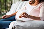 Pregnant woman finishing cigarette