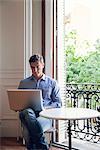 Man working on laptop computer at home