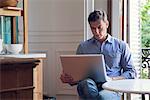 Man using laptop computer at home