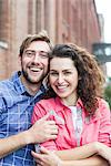 Affectionate couple smiling outdoors, portrait