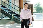 Young businessman standing in hotel lobby