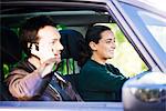 Woman driving while passenger chats on phone