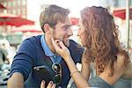 Affectionate couple sitting together outdoors