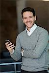 Businessman relaxing with smartphone