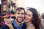 Couple embracing outdoors, portrait