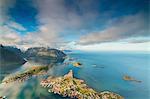 Blue sky and clouds frame the turquoise sea and the typical village, Reinebringen, Moskenesoya, Lofoten Islands, Norway, Scandinavia, Europe