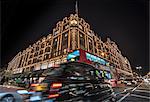 A London taxi and a London bus drive past Harrods, London, England, United Kingdom, Europe