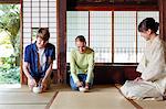 Caucasian couple enjoying tea ceremony at traditional Japanese house