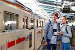 Caucasian tourist couple at train station, Tokyo, Japan