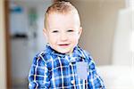 adorable toddler with blue eyes smiling and enjoying time at home