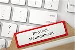 Project Management written on Red Folder Register on Background of Computer Keyboard. Closeup View. Selective Focus. 3D Rendering.