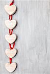 Love concept. Hearts hanging on grey rustic background