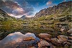 Mountain Lake Above Skok Waterfall with Rocks in Foreground and Strbsky Peak in Background at Sunset. Mlynicka Valley, High Tatra, Slovakia.