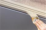 Professional Painter Cutting In With A Brush to Paint House Door Frame.