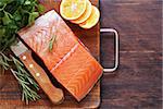 fresh red fish fillet of salmon with lemon and herbs