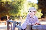 cute smiling boy student in glasses enjoying time outdoor, back to school concept