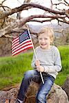 smiling caucasian boy holding american flag celebrating 4th of july, independence day