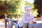 cute school boy student in glasses enjoying time outdoor, back to school concept