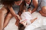 Mother And Daughter Playing With Baby At Home At Home