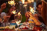 Friends With Sparklers Eating Food And Enjoying Party