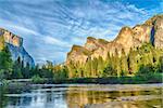 Granite cliffs reflecting in Merced river during dusk, Yosemite National Park. California, USA