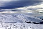 Winter mountains and gray sky before blizzard. Carpathian Mountains, Ukraine.