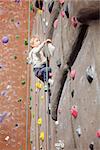 brave little boy rock climbing at indoor climbing gym, healthy and active lifestyle