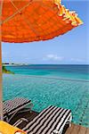 view at umbrella and two sunbeds by the infinity pool with gorgeous view of caribbean sea at anguilla island