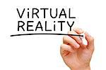 Hand writing Virtual Reality with black marker on transparent wipe board.