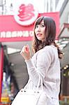 Fashionable Japanese woman at a traditional shopping street, Tokyo, Japan