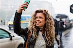 Woman in street taking selfie