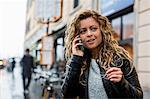 Woman in street making telephone call on mobile phone