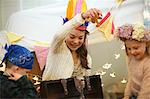 Boy and two sisters playing dress up from treasure chest