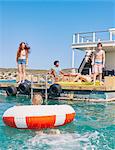 Family having fun on houseboat sun deck, Kraalbaai, South Africa