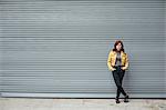 Portrait of young woman with red hair, in urban environment