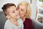 Grandmother kissing grandson's cheek