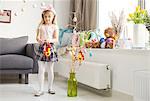 Girl making easter decorations in living room
