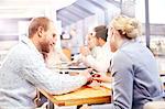 Businesswoman and man using smartphone touchscreen at office meeting