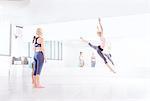 Young female ballet dancer practicing leaps in dance studio