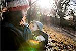 Mother holding baby boy, outdoors