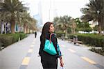 Rear view of mature female shopper carrying shopping bags, Dubai, United Arab Emirates