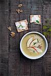 Cream of potato and curry soup with apple wedges and chives served with crispbread and cream cheese