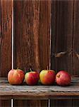 A row of fresh apples on a wooden table